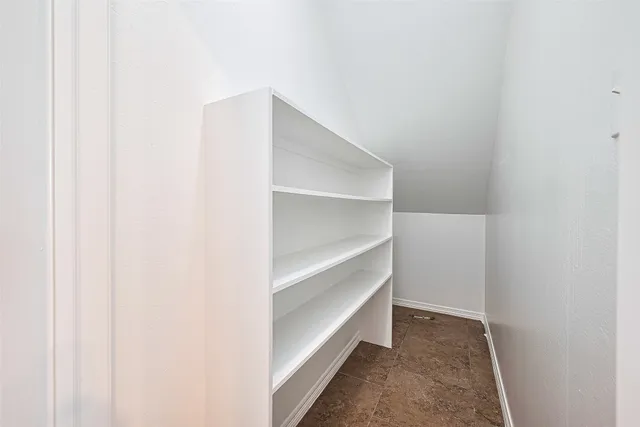 a large kitchen with kitchen island granite countertop a large window and stainless steel appliances