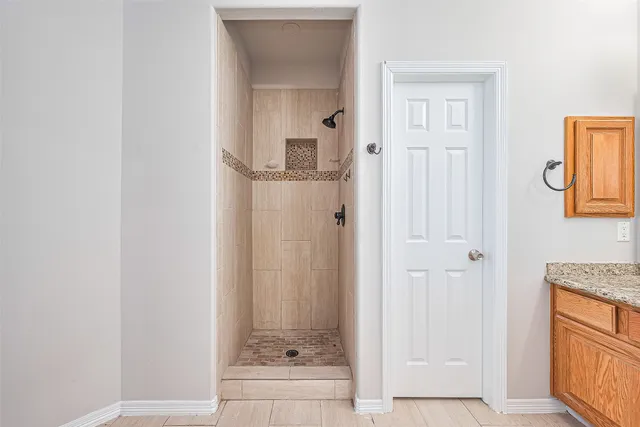 a bathroom with a glass shower door