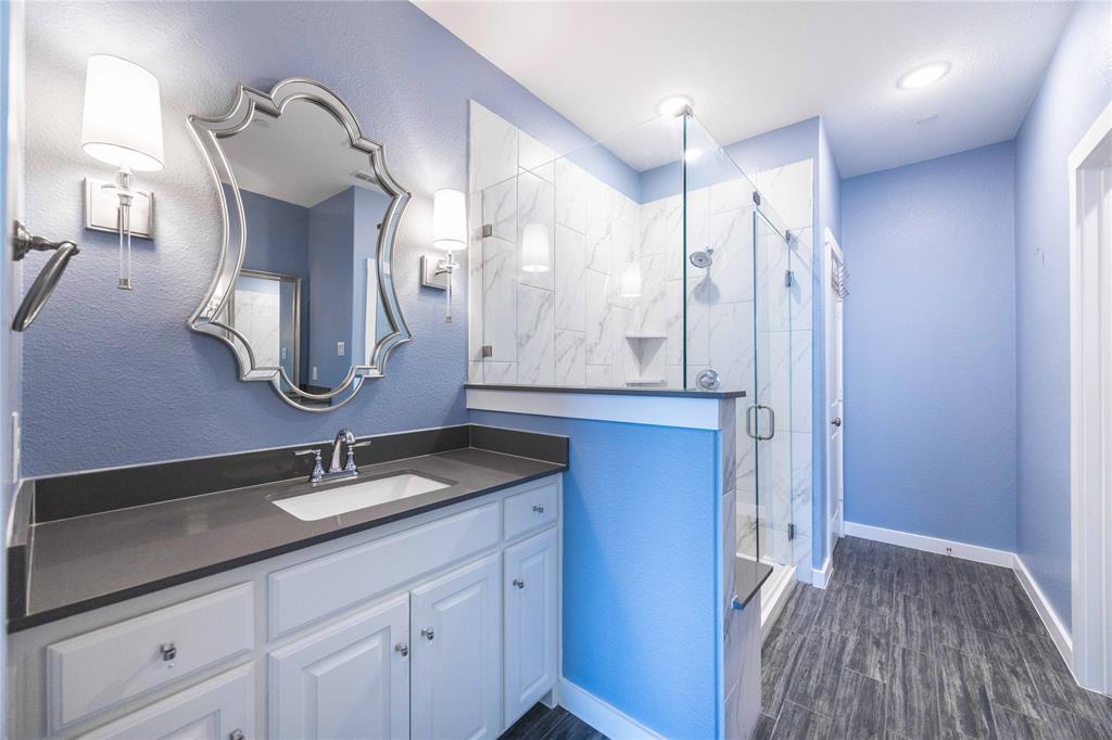 631 Cobblestone Lane Irving, TX 75039 - Photo 23 of 32 a bathroom with a double vanity sink and a mirror