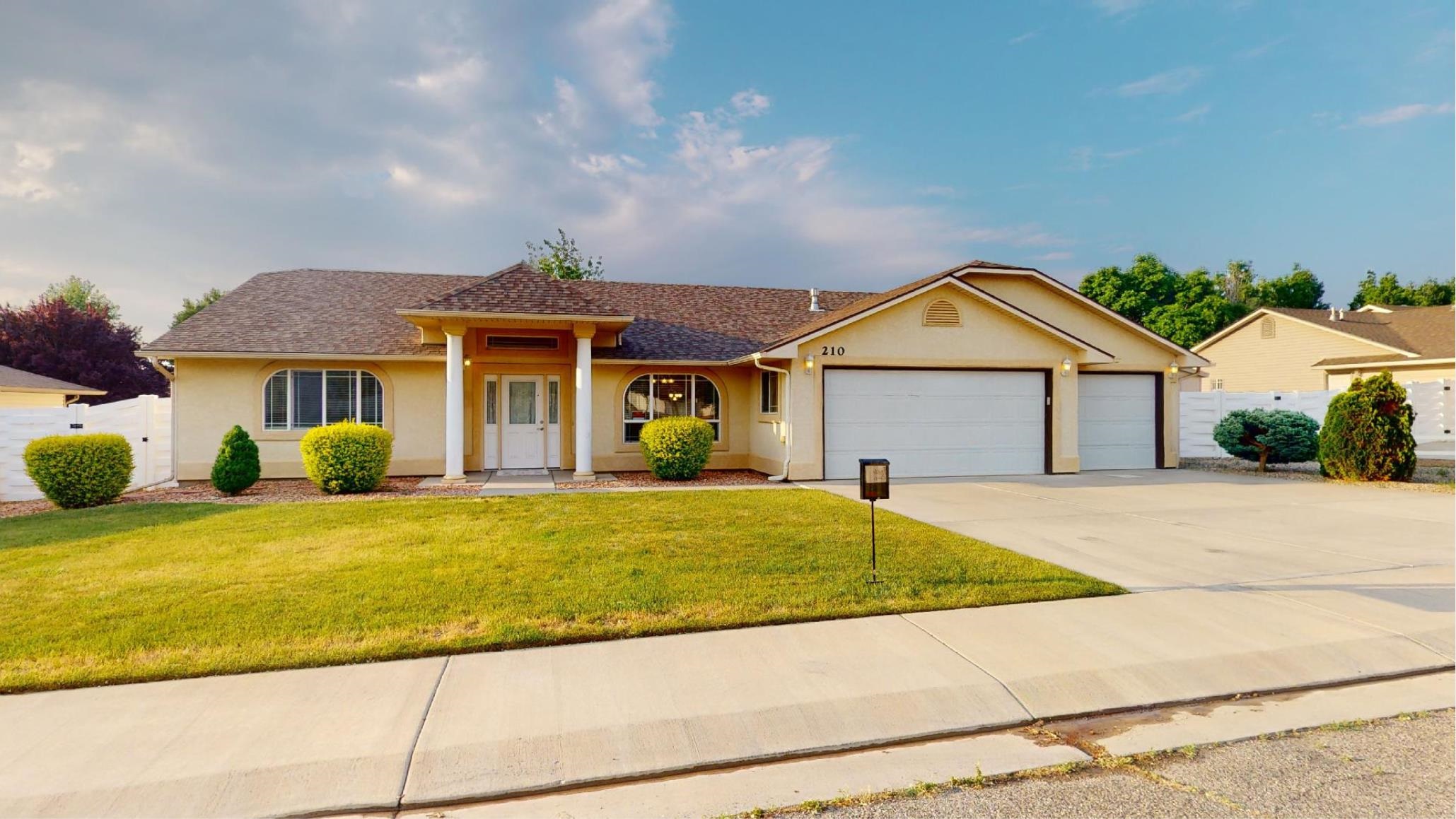 a front view of a house with a garden