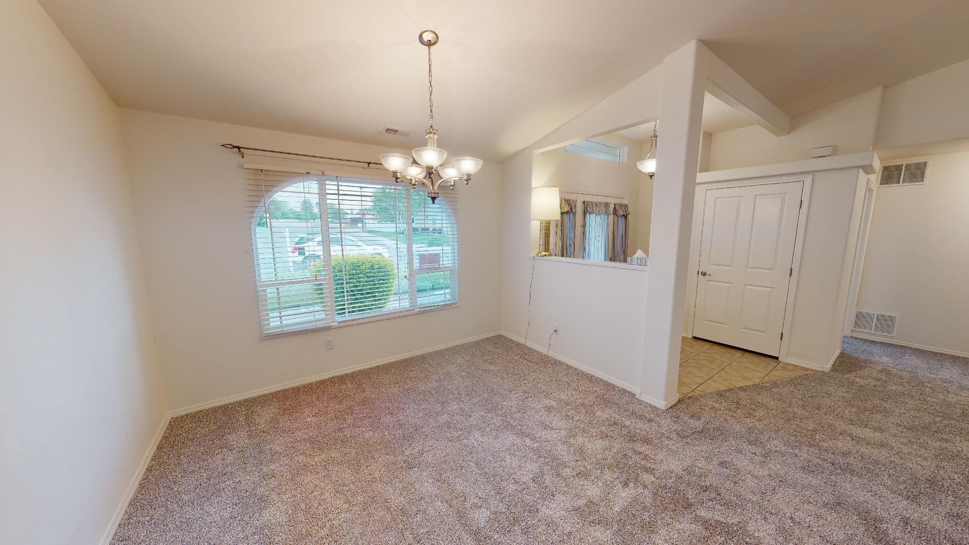 210 Limestone Circle Grand Junction, CO 81503 - Photo 11 of 32 an empty room with windows and chandelier