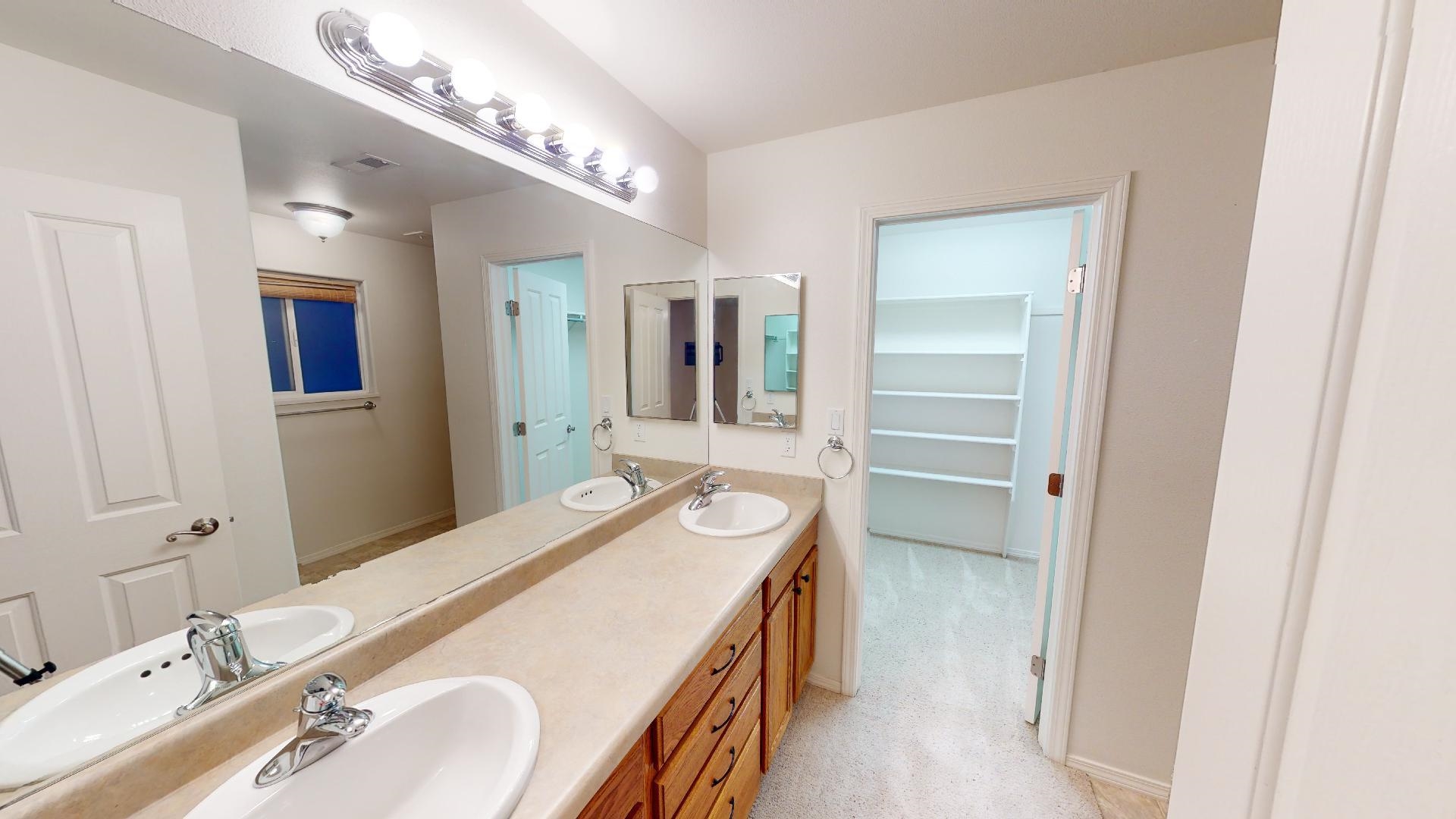 210 Limestone Circle Grand Junction, CO 81503 - Photo 15 of 32 a en suite bathroom with a double vanity sink and a mirror