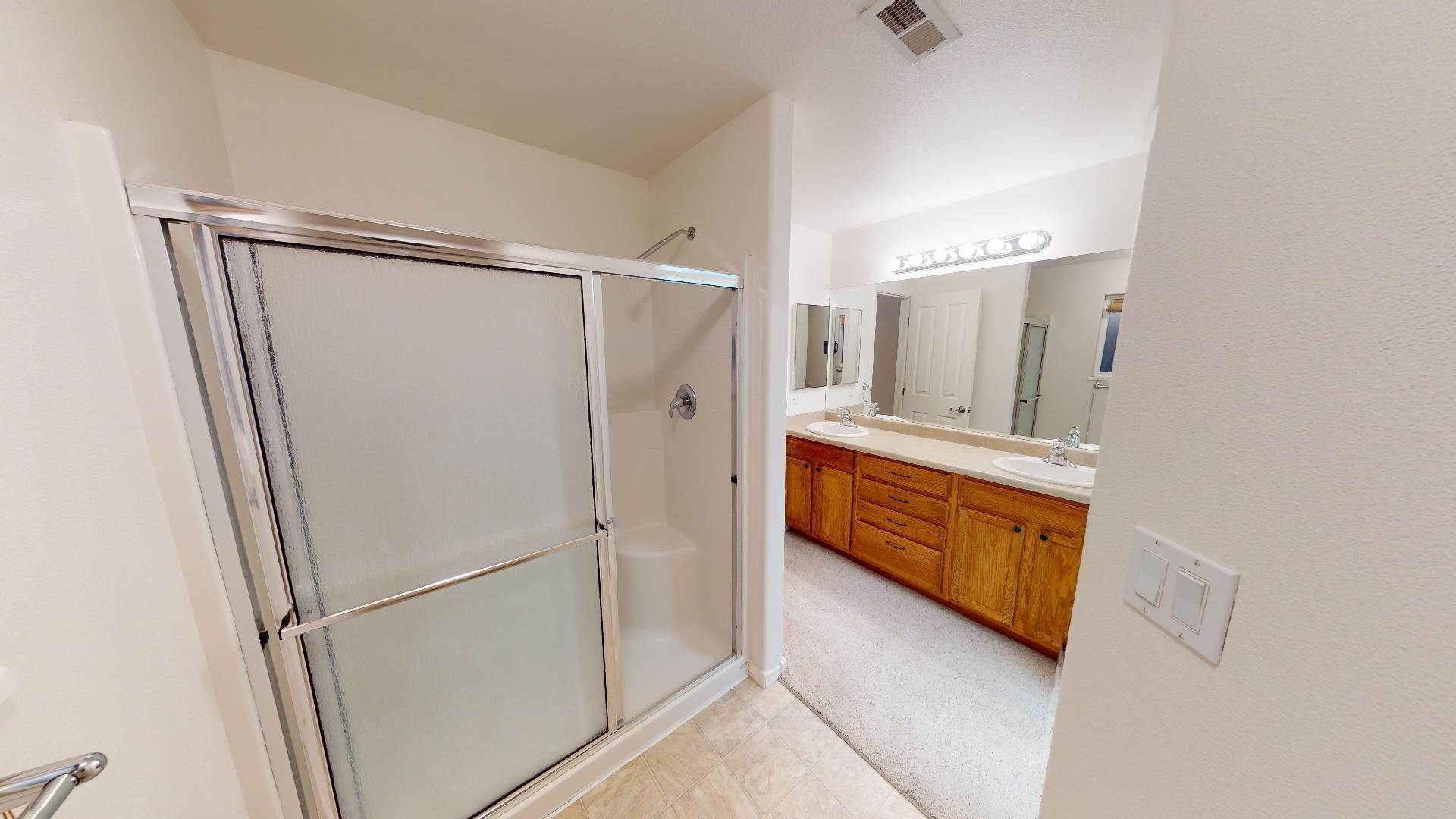 210 Limestone Circle Grand Junction, CO 81503 - Photo 16 of 32 a bathroom with a double vanity sink and mirror