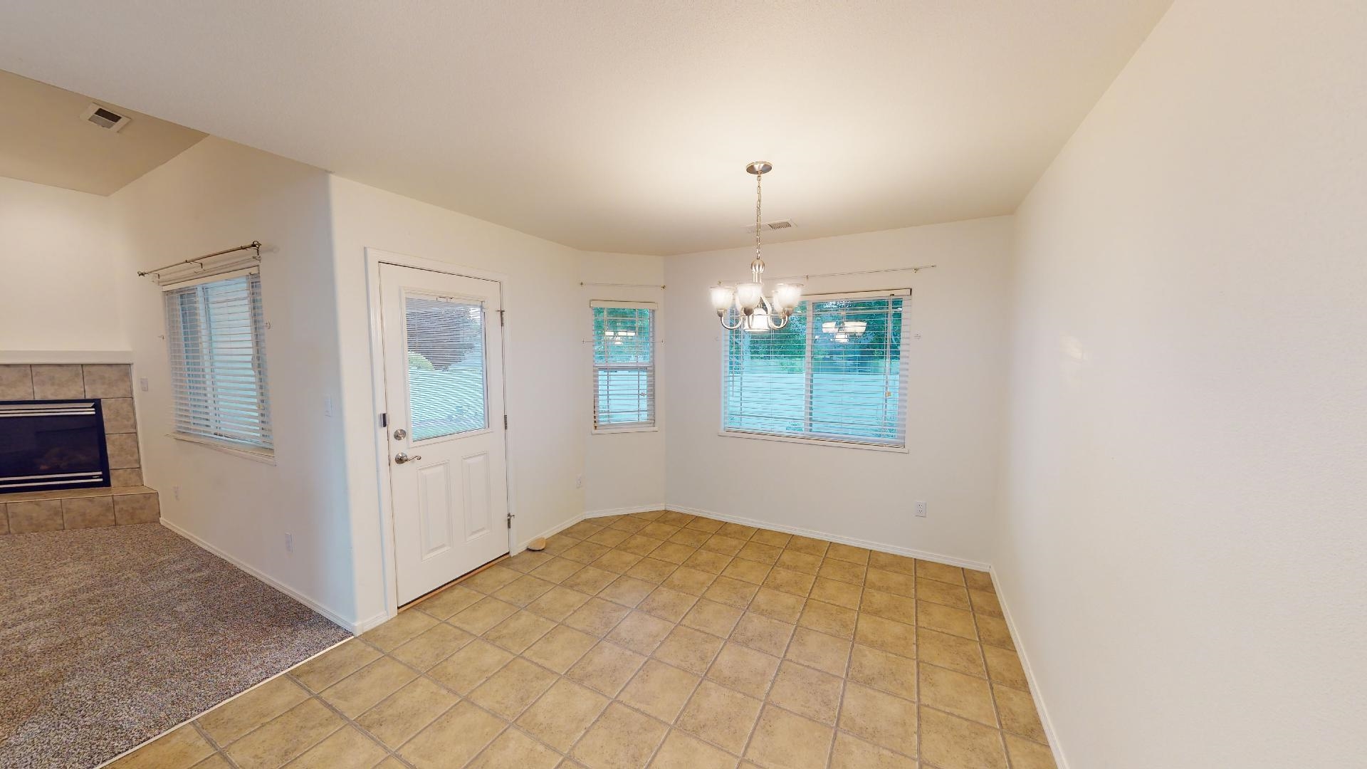 210 Limestone Circle Grand Junction, CO 81503 - Photo 6 of 32 a view of an empty room with window and chandelier fan