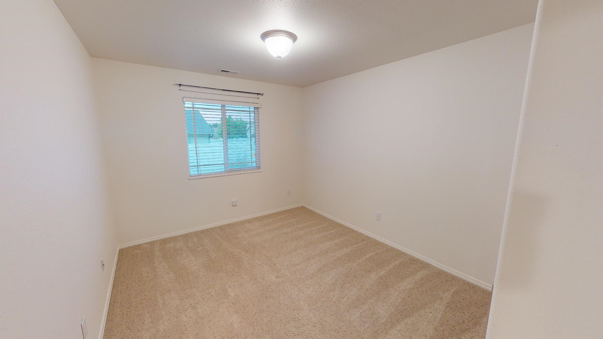 210 Limestone Circle Grand Junction, CO 81503 - Photo 9 of 32 an empty room with a window