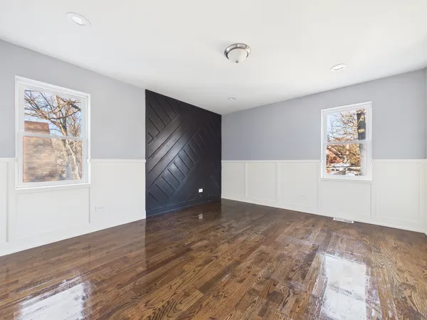 a view of empty room with wooden floor and cabinet