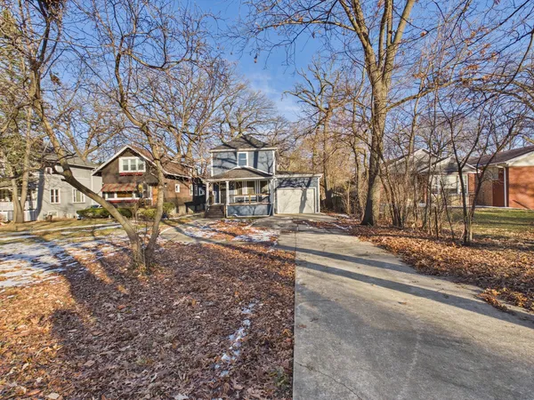 a view of a house with a yard covered in snow