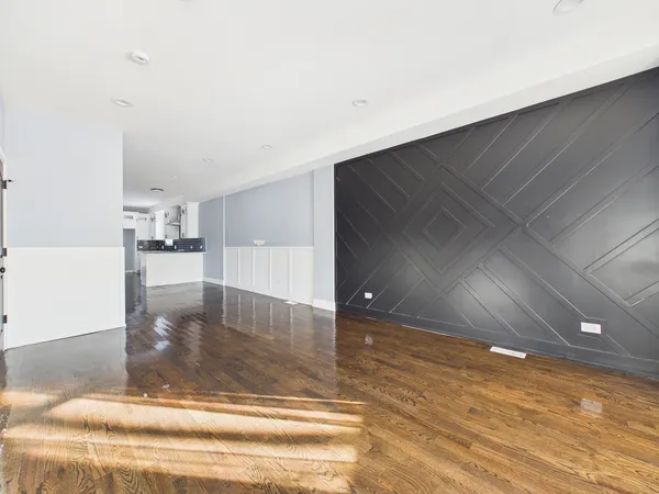 a view of an empty room and wooden floor