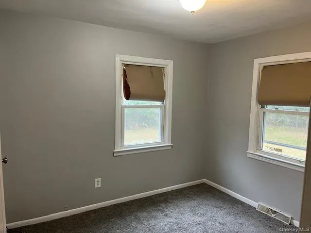 an empty room with closet area