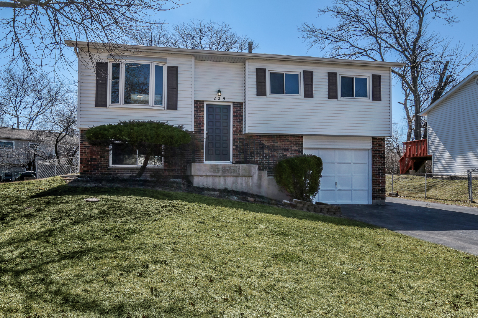 229 Riverside Drive Bolingbrook, IL 60440 - Photo 1 of 35 a front view of a house with garden