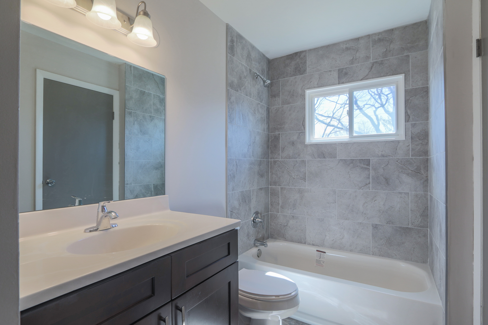 229 Riverside Drive Bolingbrook, IL 60440 - Photo 18 of 35 a bathroom with a bathtub shower sink vanity and toilet