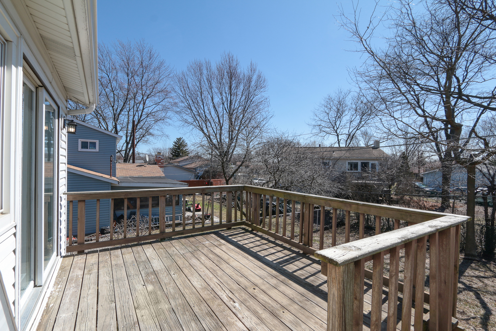 229 Riverside Drive Bolingbrook, IL 60440 - Photo 32 of 35 a balcony with wooden floor and trees