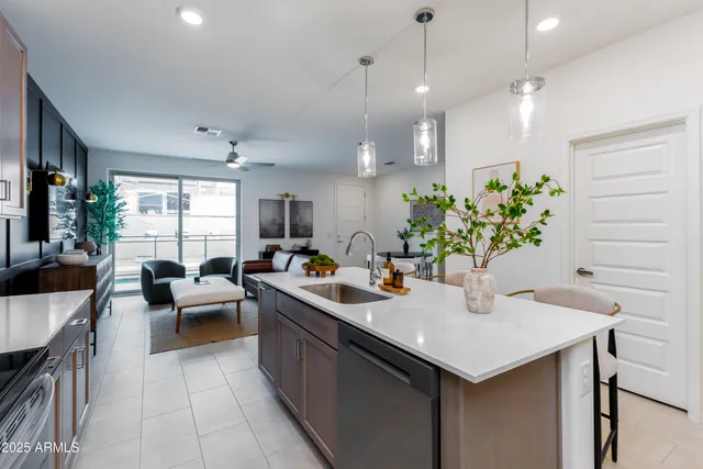a kitchen with sink refrigerator and stove