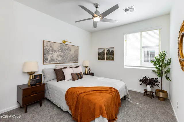 a bedroom with bed and a potted plant