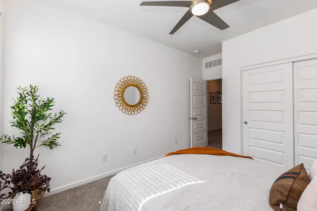 a bedroom with a bed and a potted plant