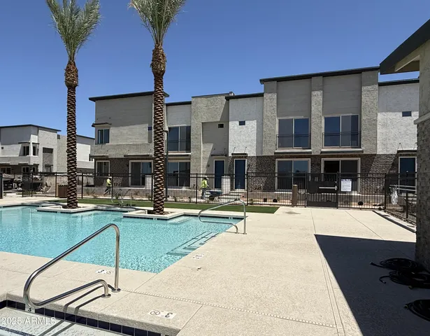 a swimming pool with outdoor seating and yard