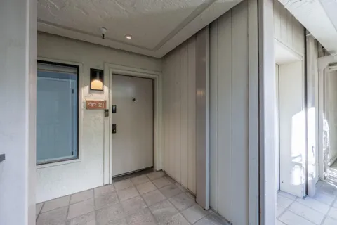 a view of a hallway with wooden shelves