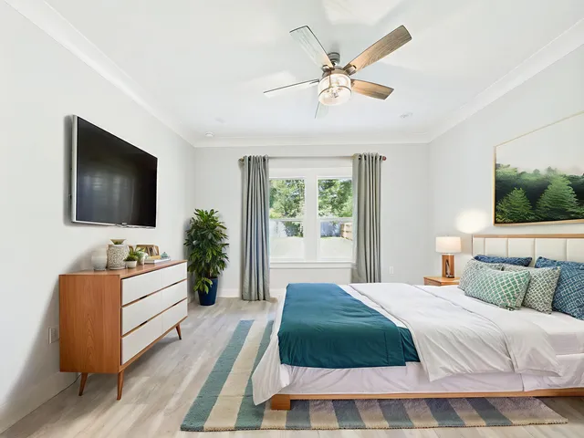 a spacious bedroom with a large bed and a flat screen tv