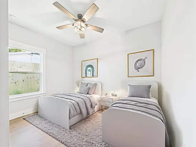 a bedroom with two beds and a chandelier
