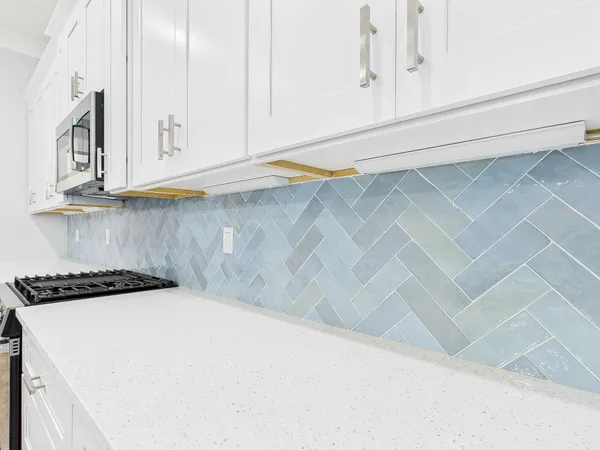 an empty room with a ceiling fan and wooden floor