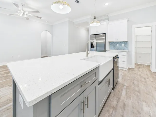 a bathroom with a sink a vanity a mirror and bathtub