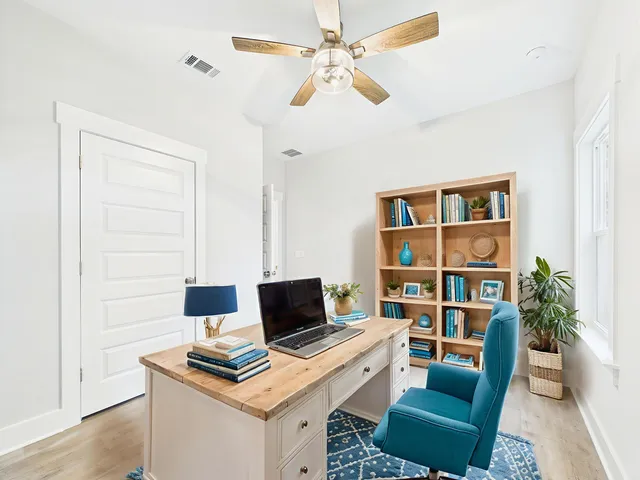 a view of a workspace with furniture and a potted plant
