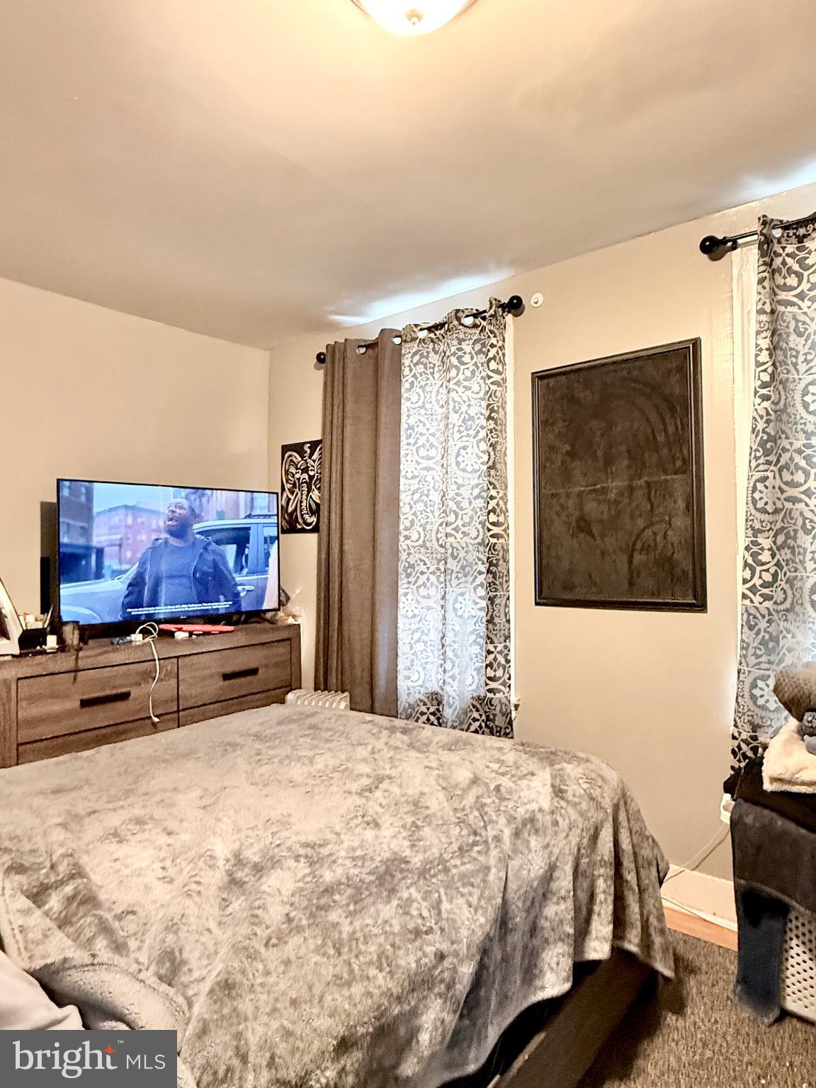 1157 Chestnut Street Camden, NJ 08103 - Photo 13 of 17 a bedroom with a bed and wooden floor
