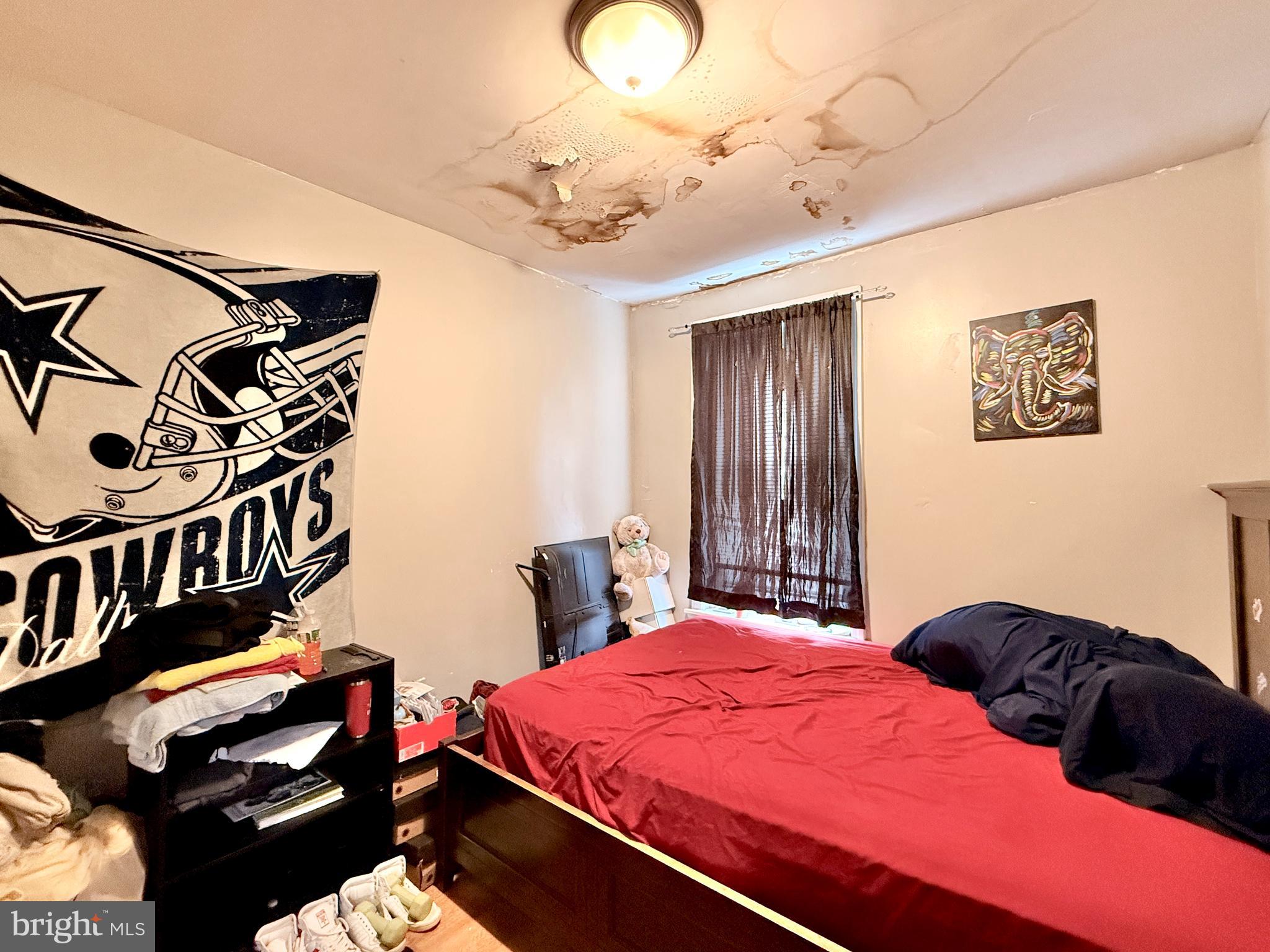 1157 Chestnut Street Camden, NJ 08103 - Photo 17 of 17 a bedroom with a bed and a chandelier