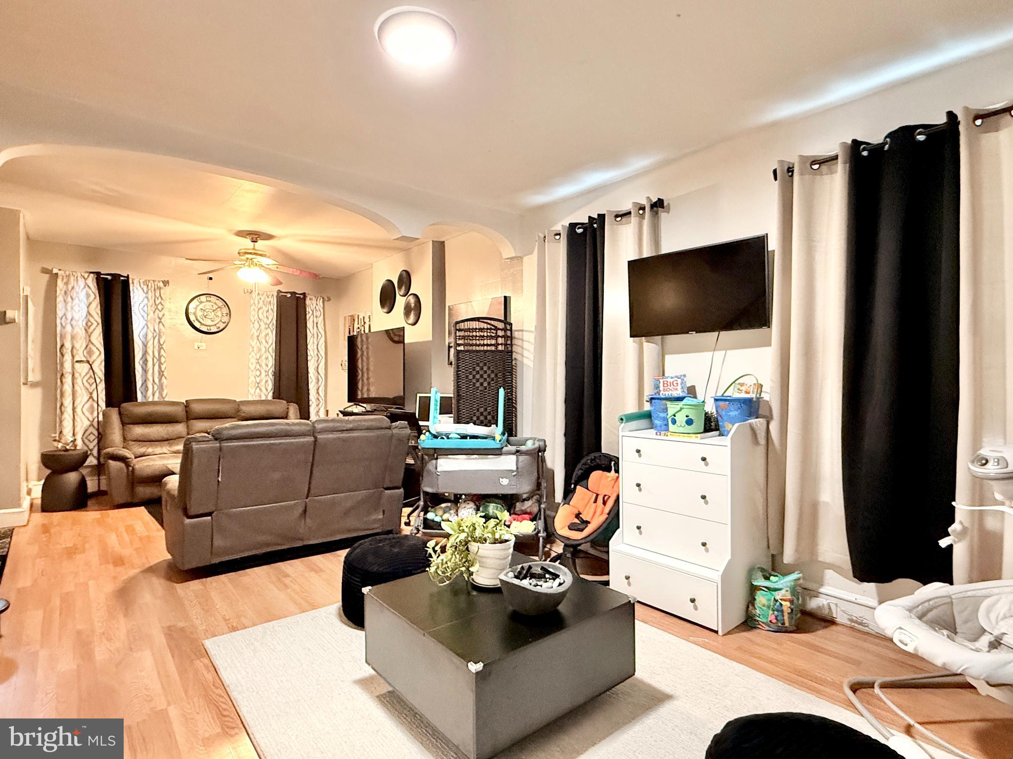 1157 Chestnut Street Camden, NJ 08103 - Photo 6 of 17 a living room with furniture and a flat screen tv