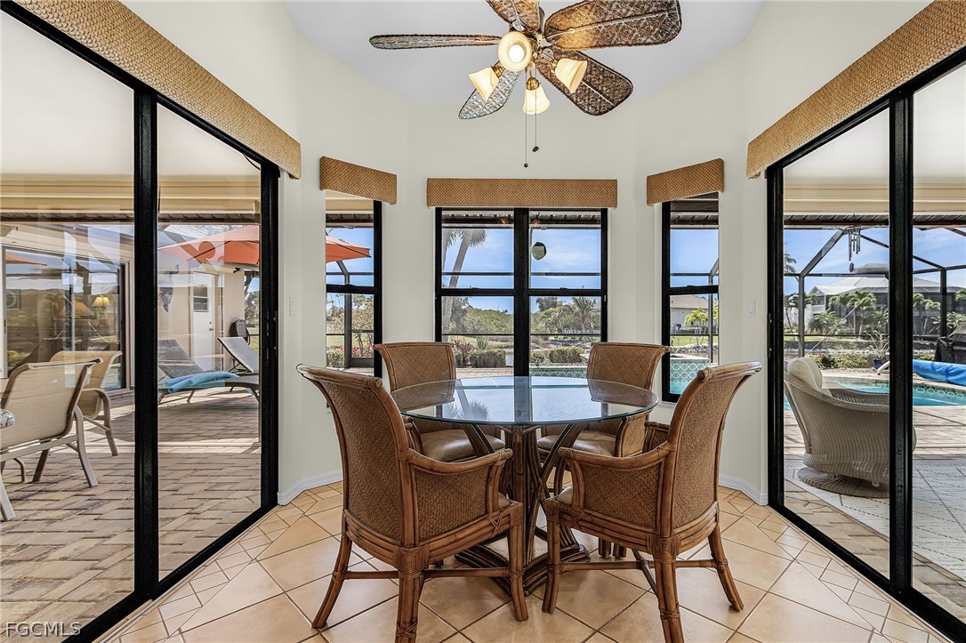 7747 Grande Pine Road Bokeelia, FL 33922 - Photo 15 of 45 a dining room with furniture a chandelier and wooden floor