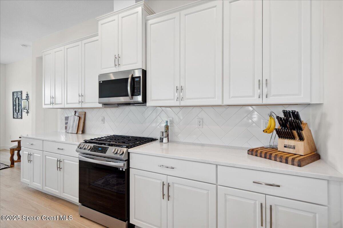 3234 Laming Way Melbourne, FL 32940 - Photo 14 of 59 a kitchen with cabinets appliances and a sink