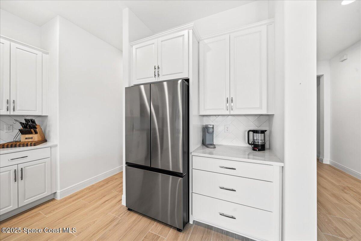 3234 Laming Way Melbourne, FL 32940 - Photo 15 of 59 a kitchen with appliances a refrigerator and cabinets
