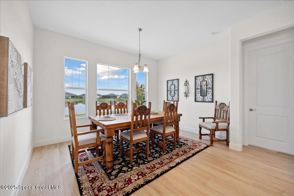 3234 Laming Way Melbourne, FL 32940 - Photo 18 of 59 a view of a dining room with furniture window and wooden floor