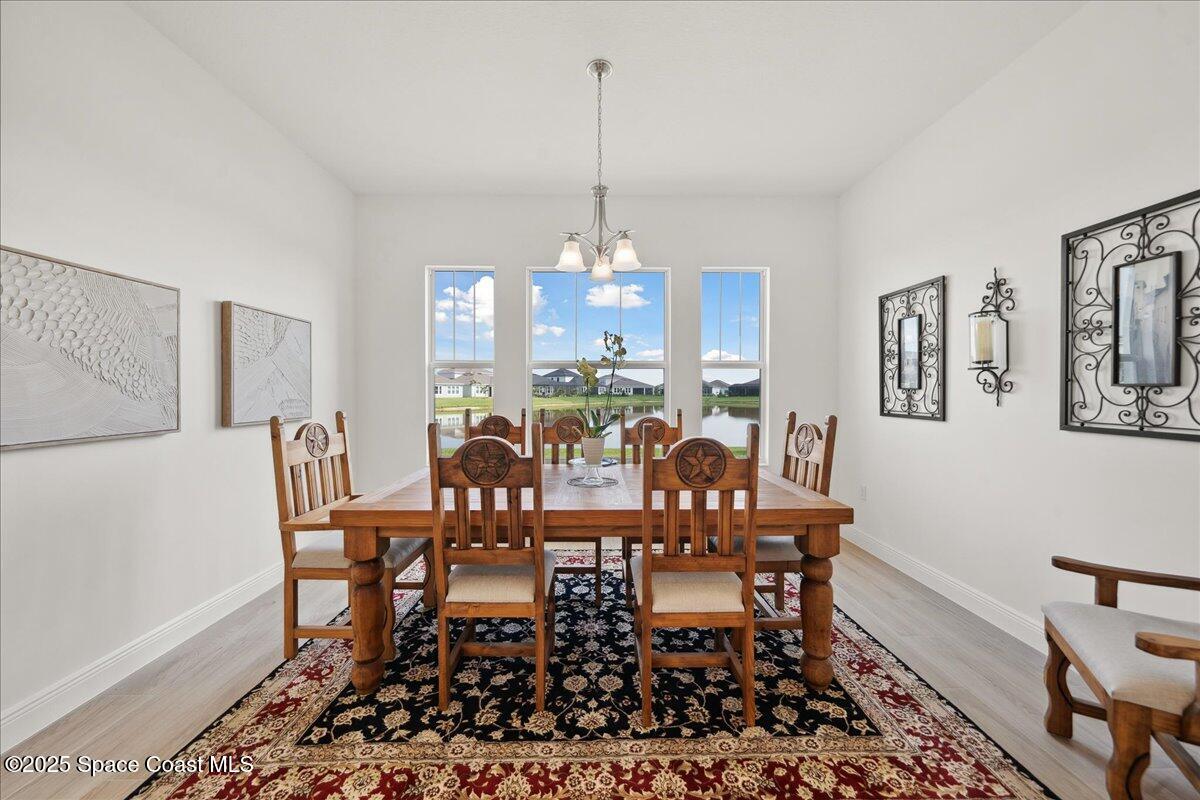 3234 Laming Way Melbourne, FL 32940 - Photo 20 of 59 a view of a dining room with furniture window and wooden floor