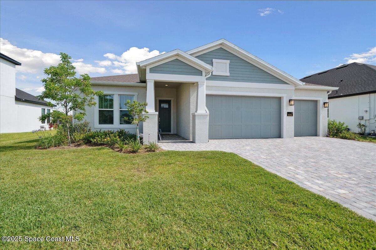 3234 Laming Way Melbourne, FL 32940 - Photo 2 of 59 a front view of a house with garden