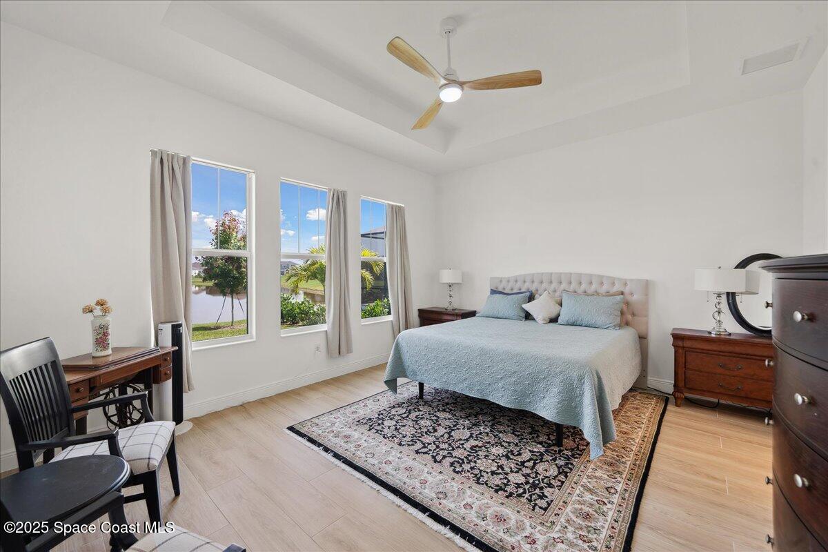 3234 Laming Way Melbourne, FL 32940 - Photo 21 of 59 a bedroom with a bed dresser and a window