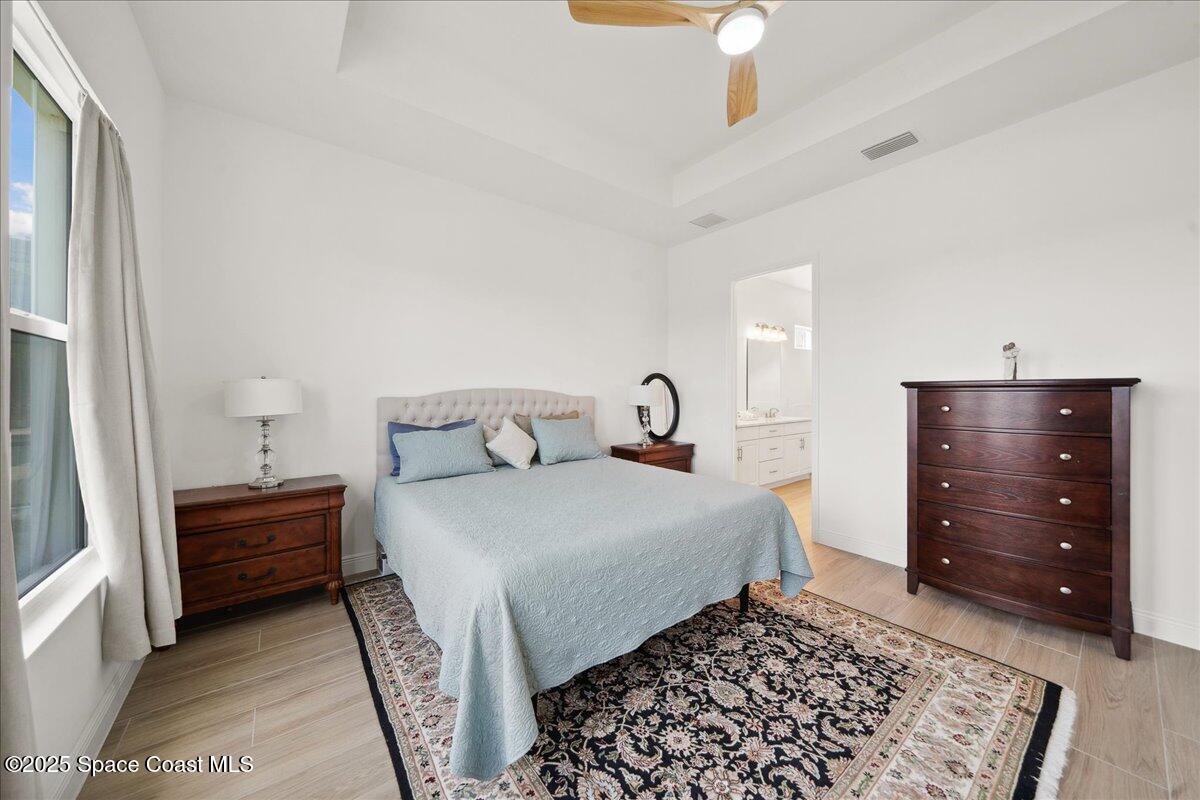 3234 Laming Way Melbourne, FL 32940 - Photo 22 of 59 a bedroom with a bed and a cabinets