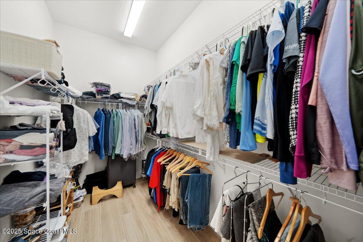 3234 Laming Way Melbourne, FL 32940 - Photo 27 of 59 a view of walk in closet with clothes