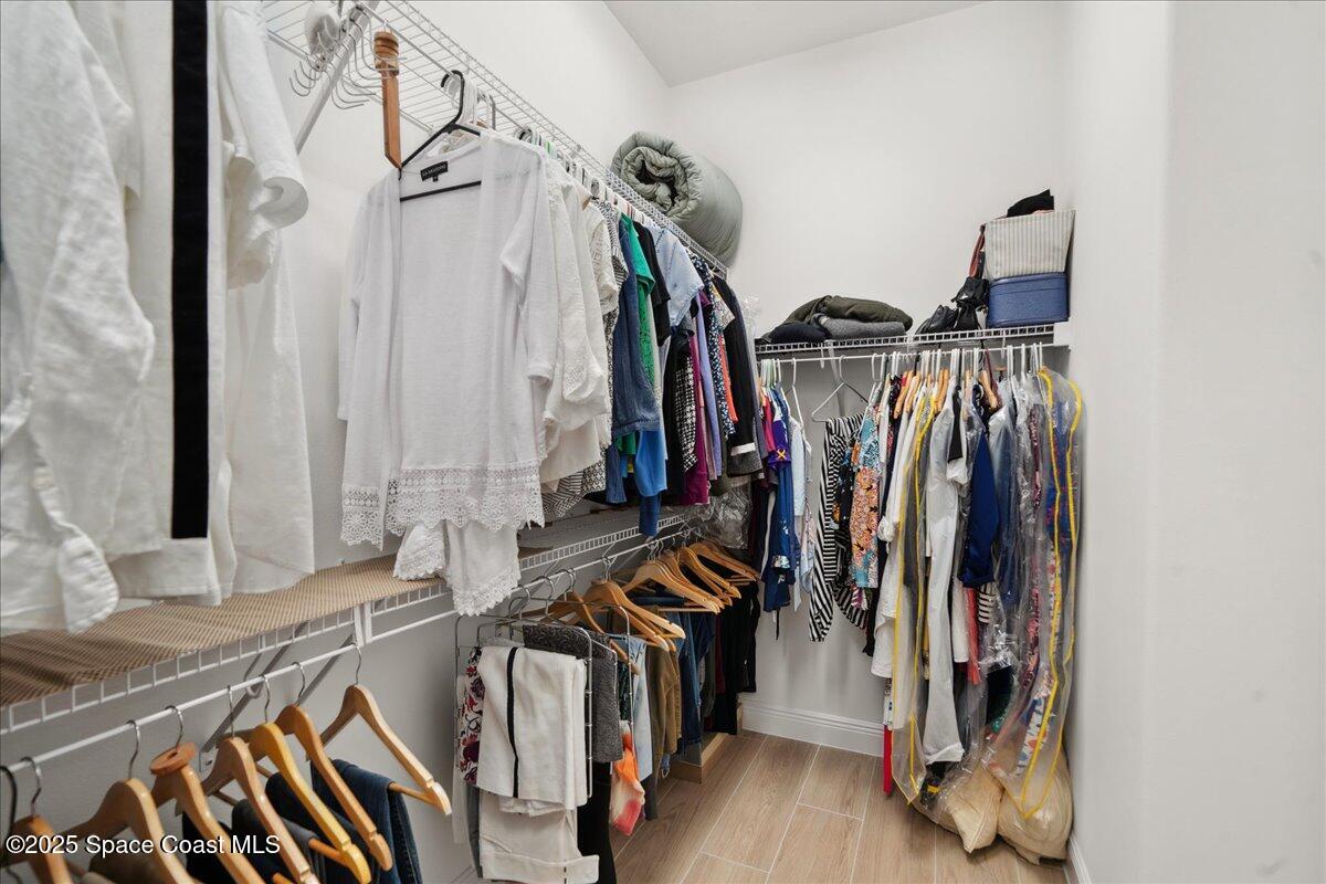 3234 Laming Way Melbourne, FL 32940 - Photo 28 of 59 a view of walk in closet with clothes and shoes