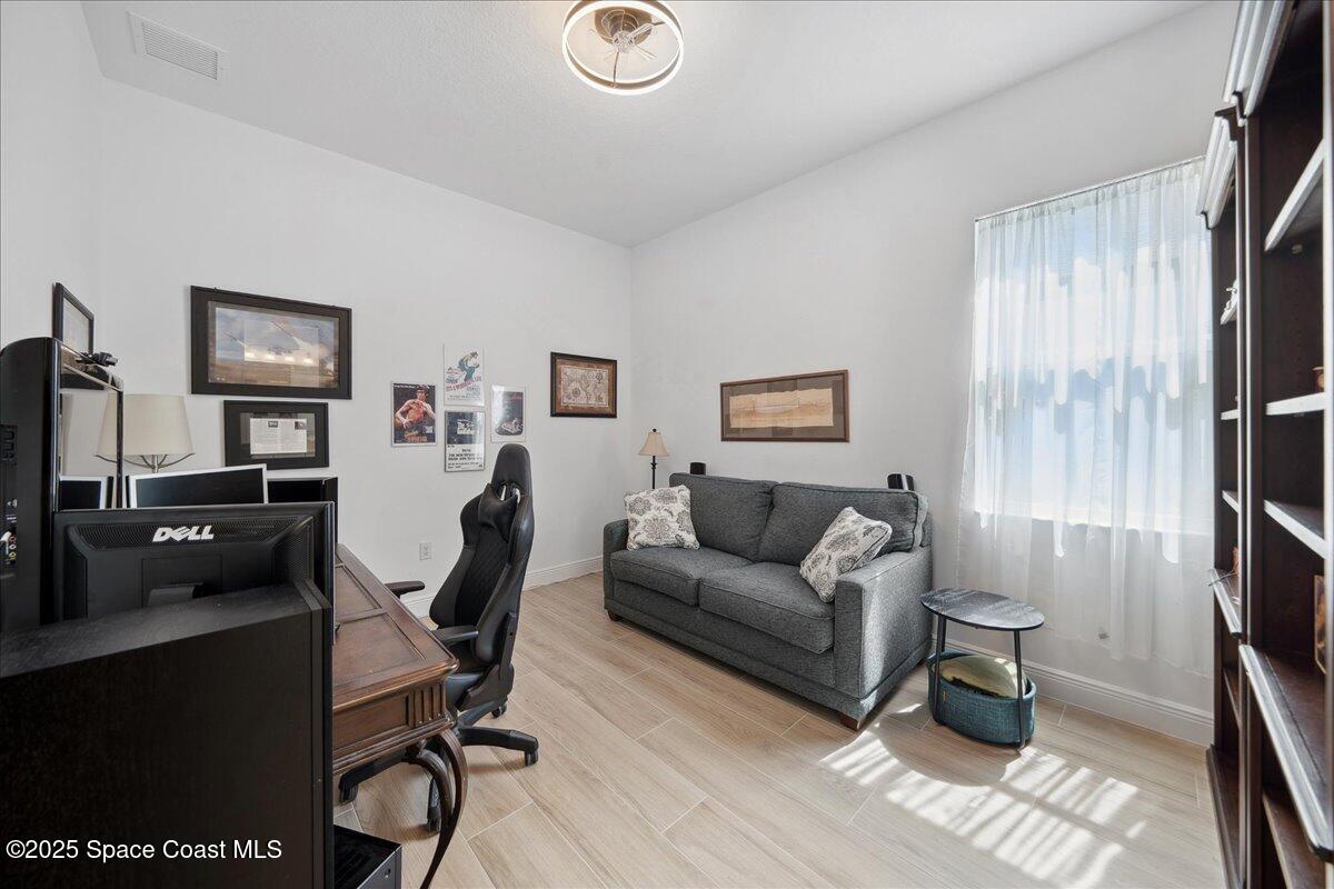 3234 Laming Way Melbourne, FL 32940 - Photo 29 of 59 a living room with furniture and a flat screen tv