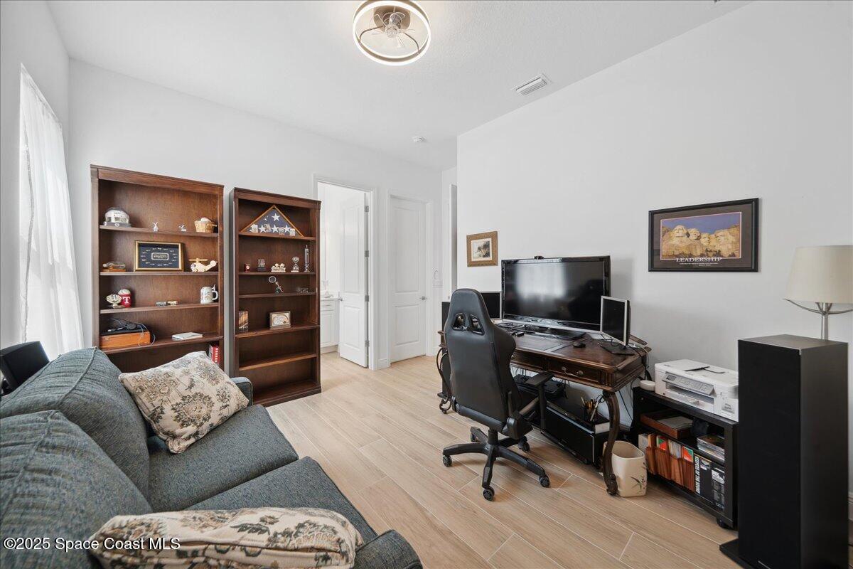 3234 Laming Way Melbourne, FL 32940 - Photo 30 of 59 a view of a livingroom with workspace and a couch