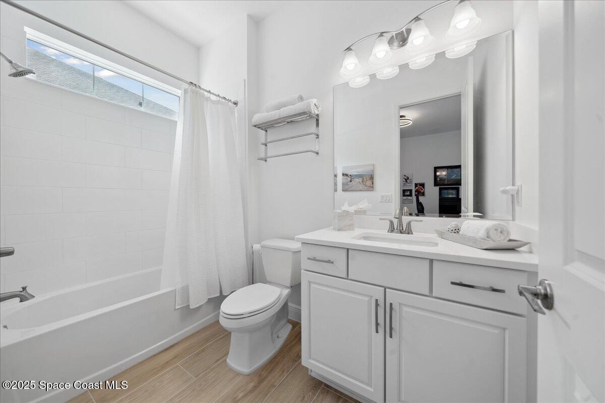 3234 Laming Way Melbourne, FL 32940 - Photo 31 of 59 a bathroom with a sink a toilet and a mirror