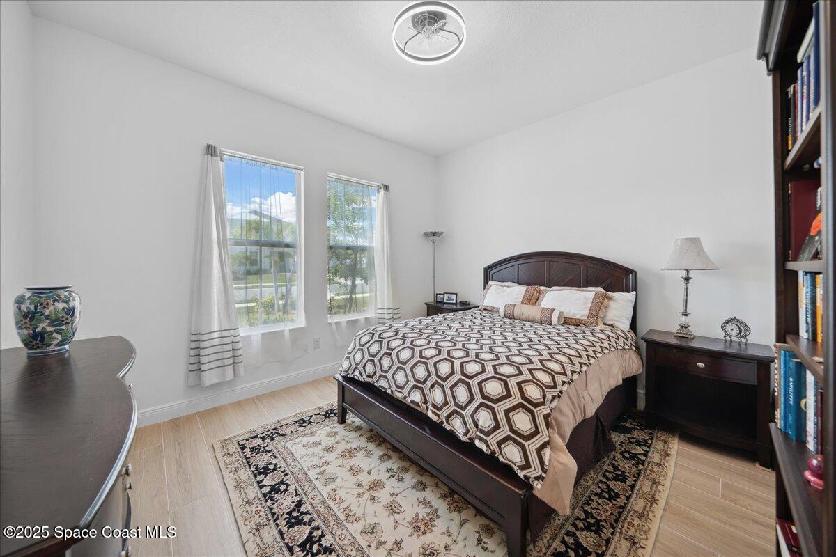 3234 Laming Way Melbourne, FL 32940 - Photo 32 of 59 a bedroom with a bed and a window