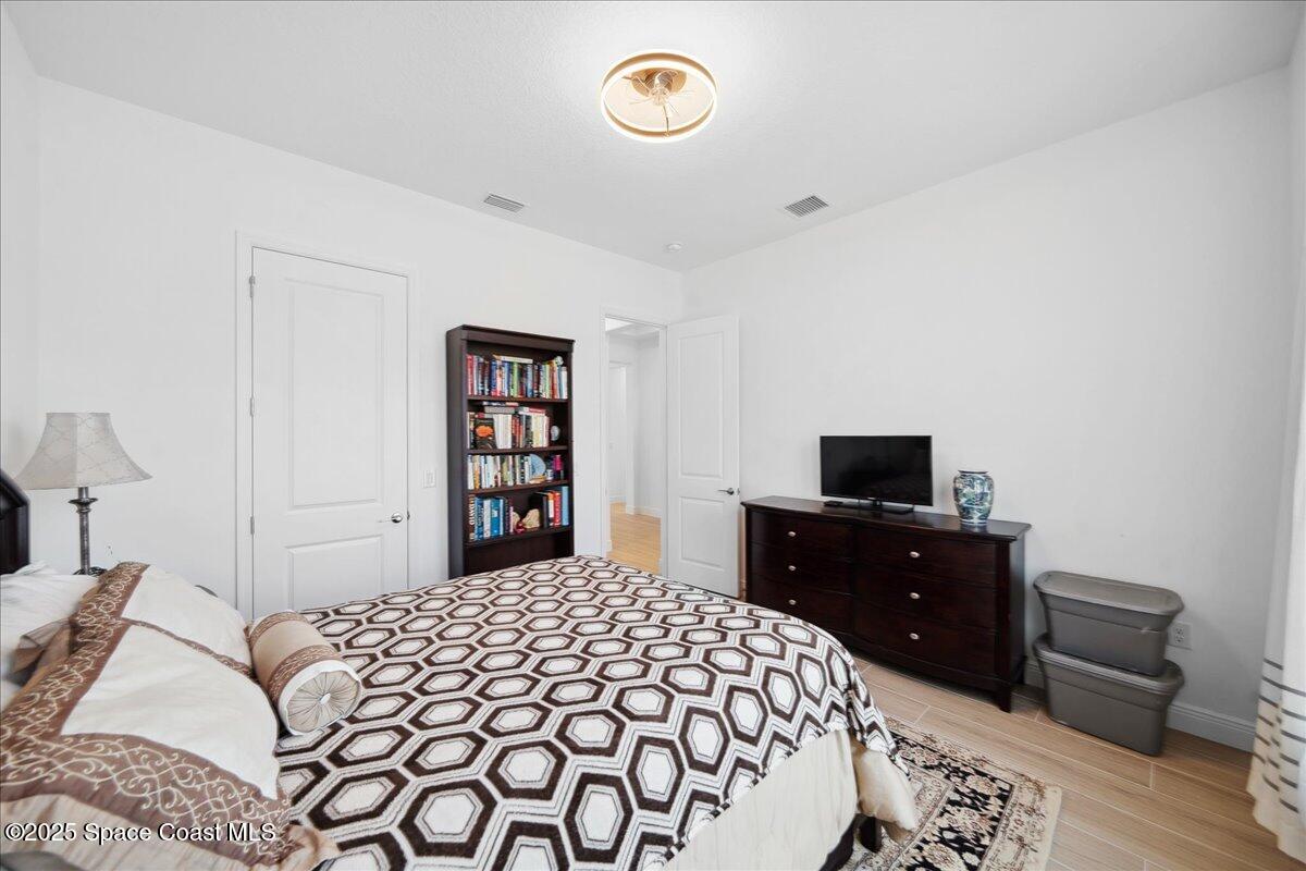 3234 Laming Way Melbourne, FL 32940 - Photo 33 of 59 a bedroom with a bed and a television