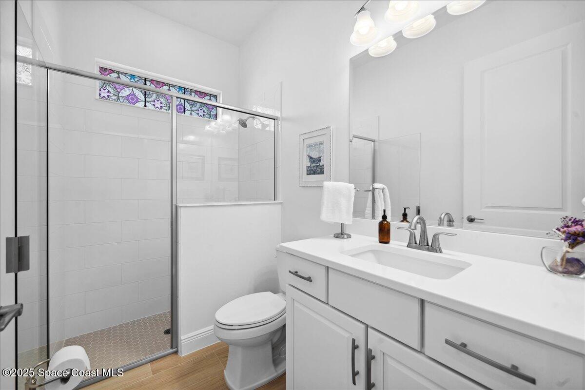 3234 Laming Way Melbourne, FL 32940 - Photo 34 of 59 a bathroom with a sink a toilet and shower