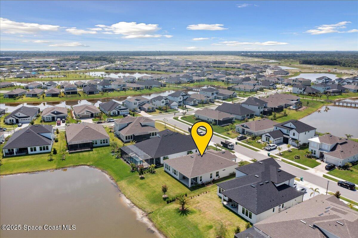 3234 Laming Way Melbourne, FL 32940 - Photo 4 of 59 an aerial view of a house with a swimming pool yard and mountain view in back