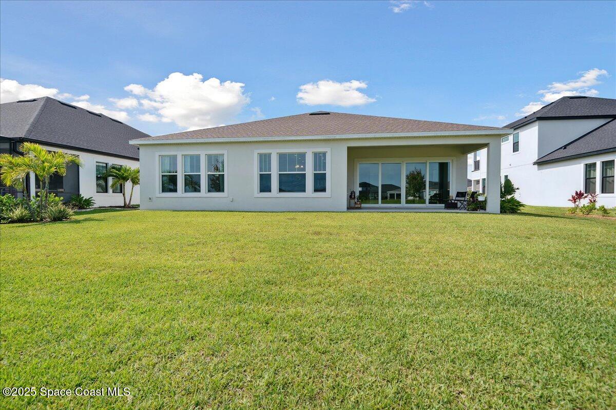 3234 Laming Way Melbourne, FL 32940 - Photo 43 of 59 a view of a house with a big yard and potted plants