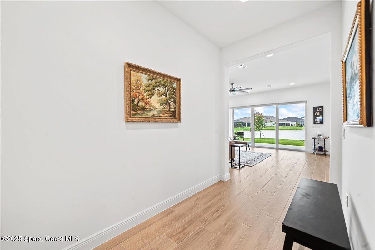 3234 Laming Way Melbourne, FL 32940 - Photo 7 of 59 a view of a hallway with wooden floor and windows