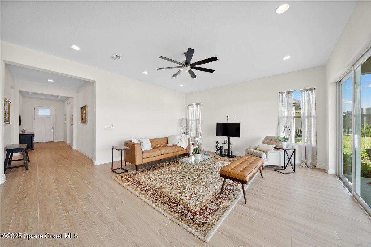 3234 Laming Way Melbourne, FL 32940 - Photo 8 of 59 a living room with furniture and a flat screen tv