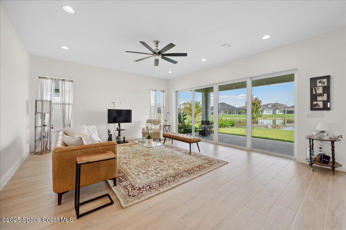 3234 Laming Way Melbourne, FL 32940 - Photo 9 of 59 a living room with furniture and a flat screen tv